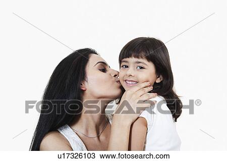Stock Image - Close-up of a woman kissing her daughter. Fotosearch