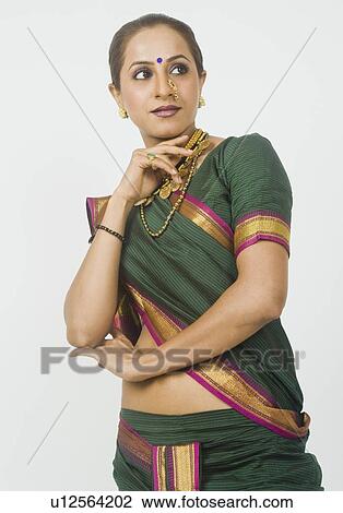 Stock Image - Close-up of a woman posing in sari. Fotosearch