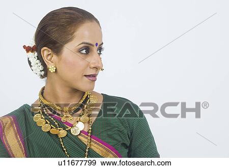 Close-up of a woman smirking View Large Photo Image Stock Photo - Close-up of a woman smirking. Fotosearch