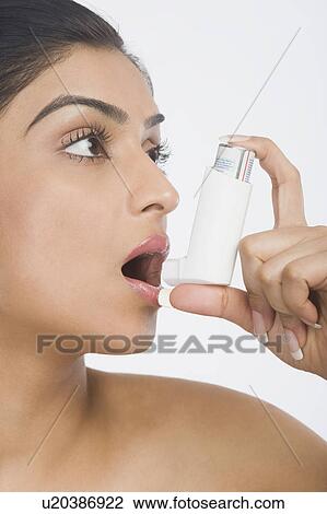 Close-up of a woman using an asthma inhaler View Large Photo Image Stock Image - Close-up of a woman using an asthma inhaler. Fotosearch