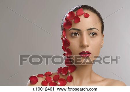 Close-up of a woman with rose petals over her body View Large Photo Image Stock Image - Close-up of a woman with rose petals over her body. Fotosearch