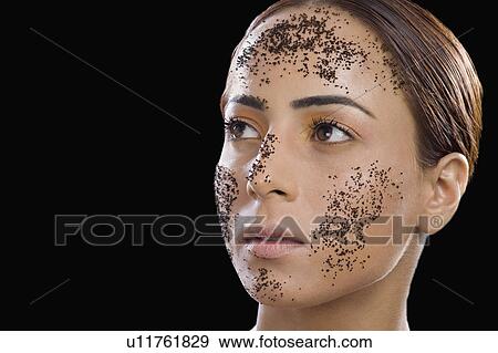 Close-up of a woman with tea leaves on her face View Large Photo Image Stock Photo - Close-up of a woman with tea leaves on her face. Fotosearch