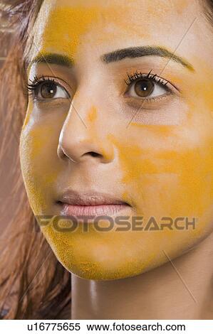 Close-up of a woman with turmeric on her face View Large Photo Image Stock Photography - Close-up of a woman with turmeric on her face. Fotosearch
