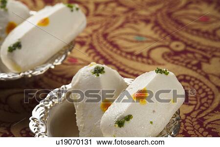 Close-up of cham cham a traditional Indian sweet made from chhena (cottage cheese) and khoya (solid milk) View Large Photo Image Stock Image - Close-up of cham cham a traditional Indian sweet made from chhena (cottage cheese) and khoya (solid milk). Fotosearch