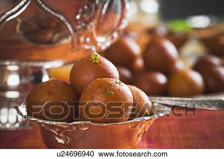 Close-up of gulab jamuns (a popular traditional Indian sweet) in a bowl View Large Photo Image Stock Image - Close-up of gulab jamuns (a popular traditional Indian sweet) in a bowl. Fotosearch