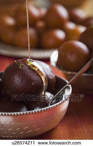 Close-up of gulab jamuns (a popular traditional Indian sweet) in a bowl View Large Photo Image Stock Image - Close-up of gulab jamuns (a popular traditional Indian sweet) in a bowl. Fotosearch