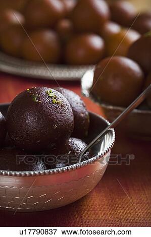 Close-up of gulab jamuns (a popular traditional Indian sweet) in a bowl View Large Photo Image Stock Photo - Close-up of gulab jamuns (a popular traditional Indian sweet) in a bowl. Fotosearch