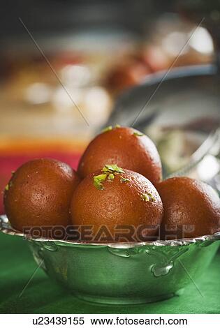 Close-up of gulab jamuns (a popular traditional Indian sweet) in a bowl View Large Photo Image Stock Photography - Close-up of gulab jamuns (a popular traditional Indian sweet) in a bowl. Fotosearch