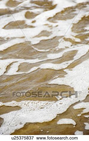 Close-up of surf on sand, Goa, India View Large Photo Image Stock Photo - Close-up of surf on sand, Goa, India. Fotosearch