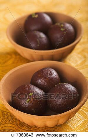 Close-up of two bowls of gulab jamuns (a popular traditional Indian sweet) View Large Photo Image Stock Image - Close-up of two bowls of gulab jamuns (a popular traditional Indian sweet). Fotosearch