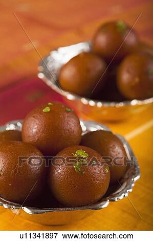 Close-up of two bowls of gulab jamuns (a popular traditional Indian sweet) View Large Photo Image Stock Photo - Close-up of two bowls of gulab jamuns (a popular traditional Indian sweet). Fotosearch
