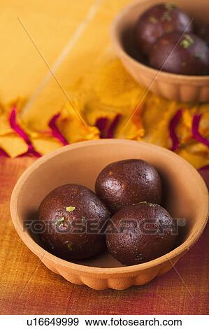Stock Photo - Close-up of two bowls of gulab jamuns (a popular traditional Indian sweet). Fotosearch