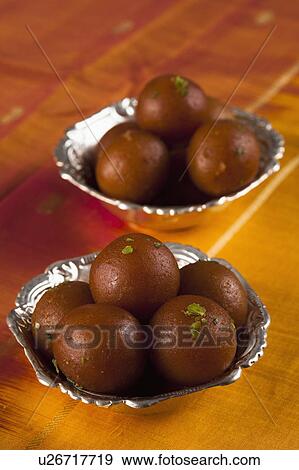 Stock Photo - Close-up of two bowls of gulab jamuns (a popular traditional Indian sweet). Fotosearch