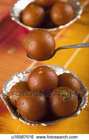 Stock Photograph - Close-up of two bowls of gulab jamuns (a popular traditional Indian sweet). Fotosearch