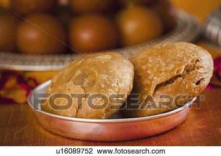 Close-up of two kachories (deep fried traditional Indian snack) in a bowl View Large Photo Image Stock Image - Close-up of two kachories (deep fried traditional Indian snack) in a bowl. Fotosearch