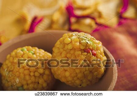 Close-up of two motichoor laddoos (a popular traditional Indian sweet) in a bowl View Large Photo Image Stock Photo - Close-up of two motichoor laddoos (a popular traditional Indian sweet) in a bowl. Fotosearch