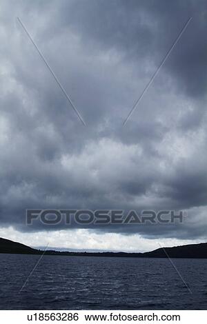 Stock Photograph - Clouds over a lake, Lakes of Killarney, County Kerry, Republic of Ireland. Fotosearch