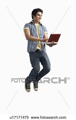 College student using a laptop and jumping View Large Photo Image Stock Photography - College student using a laptop and jumping. Fotosearch