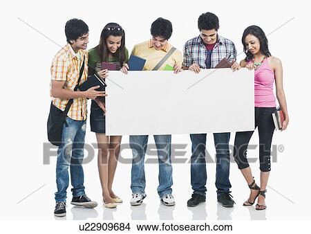 Picture - College students holding a blank placard. Fotosearch