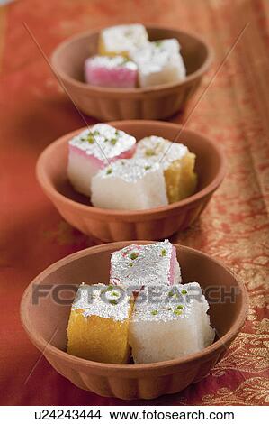 Colorful coconut burfi in bowls View Large Photo Image Picture - Colorful coconut burfi in bowls. Fotosearch