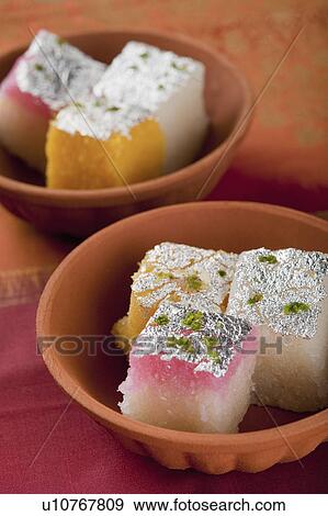 Colorful coconut burfi in bowls View Large Photo Image Stock Photo - Colorful coconut burfi in bowls. Fotosearch