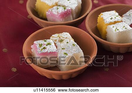Colorful coconut burfi in bowls View Large Photo Image Stock Photograph - Colorful coconut burfi in bowls. Fotosearch