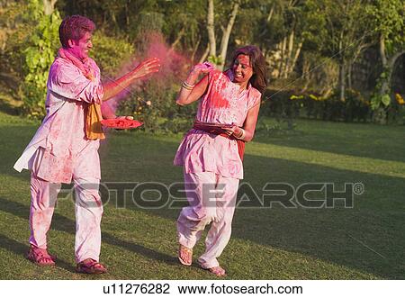 Couple celebrating Holi in a garden View Large Photo Image Stock Image - Couple celebrating Holi in a garden. Fotosearch