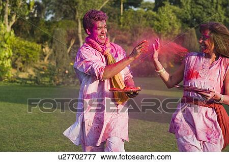 Couple celebrating Holi in a garden View Large Photo Image Stock Photo - Couple celebrating Holi in a garden. Fotosearch