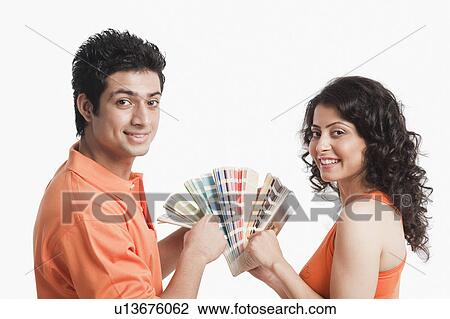 Couple choosing color from color swatches for their house View Large Photo Image Stock Image - Couple choosing color from color swatches for their house. Fotosearch