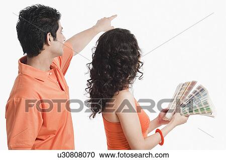 Couple choosing color from color swatches for their house View Large Photo Image Stock Image - Couple choosing color from color swatches for their house. Fotosearch