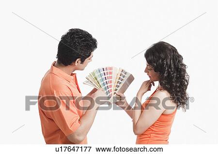 Couple choosing color from color swatches for their house View Large Photo Image Stock Photo - Couple choosing color from color swatches for their house. Fotosearch