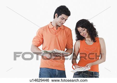Couple choosing color from color swatches for their house View Large Photo Image Stock Photograph - Couple choosing color from color swatches for their house. Fotosearch