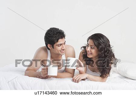 Couple drinking coffee on the bed View Large Photo Image Stock Image - Couple drinking coffee on the bed. Fotosearch