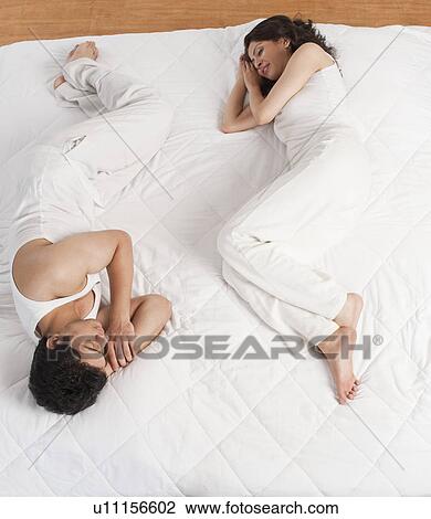 Stock Image - Couple lying on the bed. Fotosearch