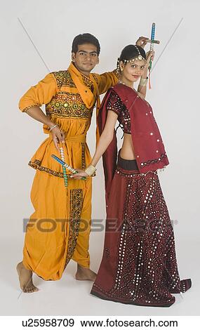 Stock Photo - Couple performing dandiya. Fotosearch