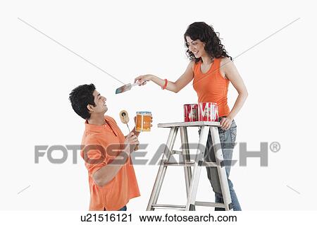 Couple playing with paints in their house View Large Photo Image Stock Image - Couple playing with paints in their house. Fotosearch