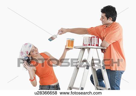 Couple playing with paints in their house View Large Photo Image Stock Photo - Couple playing with paints in their house. Fotosearch