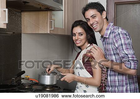 Couple preparing food in the kitchen View Large Photo Image Stock Photograph - Couple preparing food in the kitchen. Fotosearch