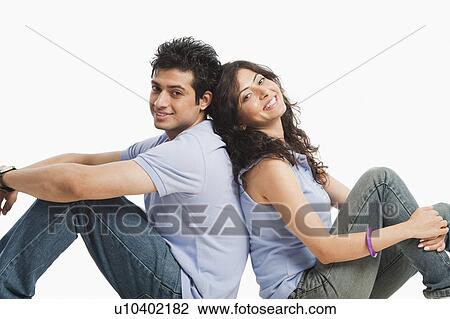 Couple sitting back to back and smiling View Large Photo Image Stock Image - Couple sitting back to back and smiling. Fotosearch
