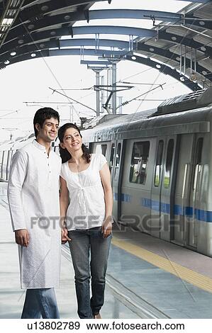 Stock Photo - Couple standing at a subway station. Fotosearch