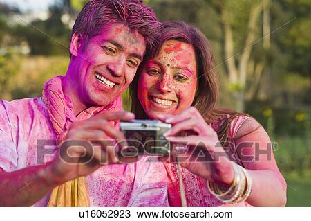 Couple taking a picture of themselves on Holi View Large Photo Image Stock Image - Couple taking a picture of themselves on Holi. Fotosearch