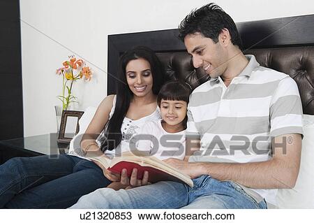 Couple teaching their daughter in the bedroom View Large Photo Image Stock Image - Couple teaching their daughter in the bedroom. Fotosearch