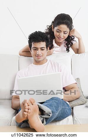 Couple using a laptop View Large Photo Image Stock Photography - Couple using a laptop. Fotosearch