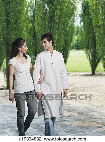 Couple walking in a park View Large Photo Image Stock Image - Couple walking in a park. Fotosearch