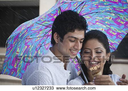 Stock Image - Couple with an ice cream. Fotosearch