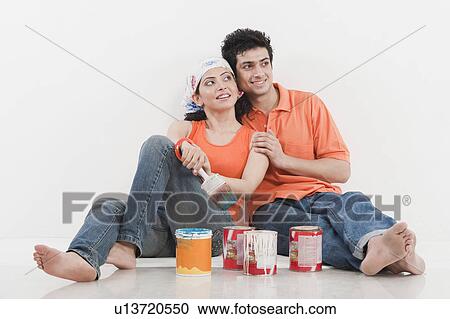 Stock Image - Couple with paint cans. Fotosearch