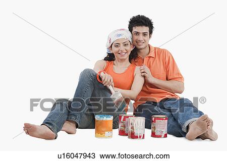 Stock Image - Couple with paint cans. Fotosearch