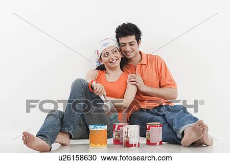 Couple with paint cans View Large Photo Image Stock Image - Couple with paint cans. Fotosearch