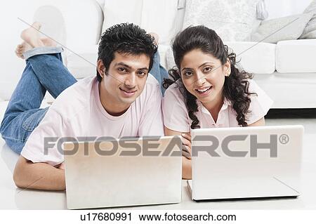 Couple working on laptops View Large Photo Image Stock Image - Couple working on laptops. Fotosearch
