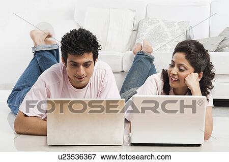 Couple working on laptops View Large Photo Image Stock Photo - Couple working on laptops. Fotosearch